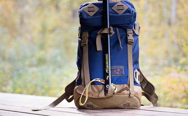 A Guide's Pack with an ice axe attached through the ice axe loop and lashed to the front using the front lash point.